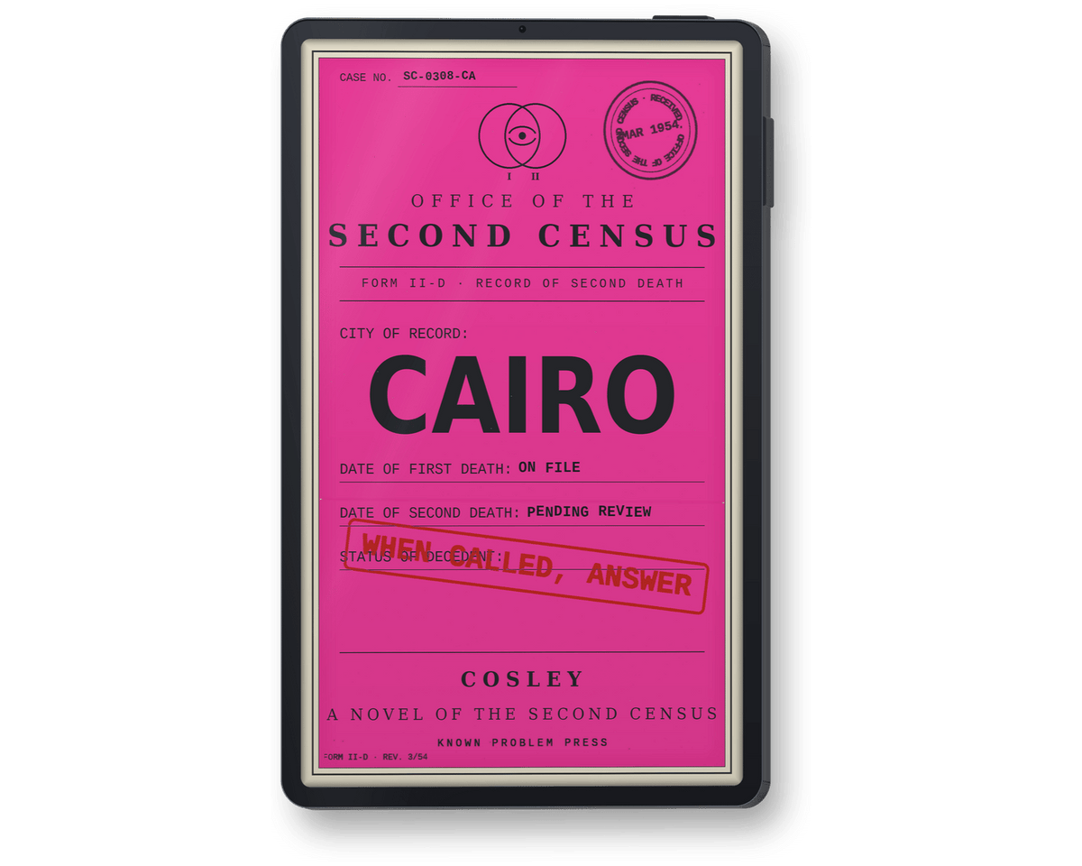 A black e-reader showing book 'Cairo: A Novel of the Second Census' by Cosley, with a bright pink front panel featuring printed text and stamps, including 'CAIRO' and a red stamp reading 'WHEN CALLED, ANSWER'.